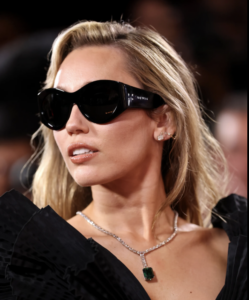 Miley Cyrus on the red carpet wearing a platinum pendant set with an emerald of over 15 carats